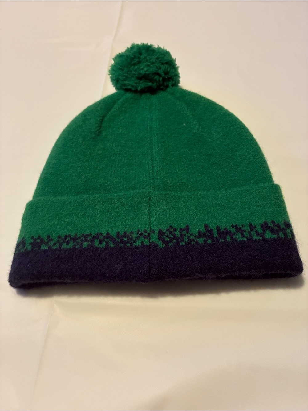 Kids Pom Pom Beanie Hat in Emerald Green with Blue Lettering - Picture 2 of 2